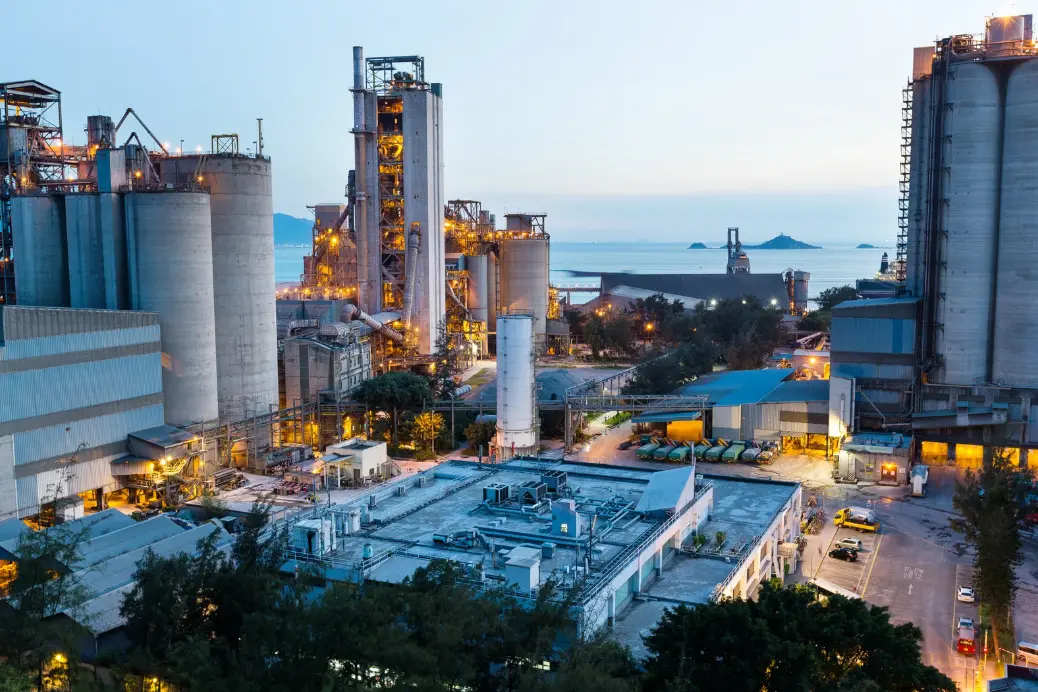 A mom holding a girl at sunset as she points to the horizon.